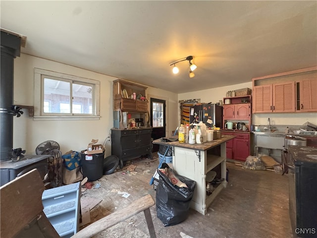 37754 County Route 194, Antwerp, NY 13608 - kitchen with a wood stove, open shelves, dark countertops, and freestanding refrigerator
