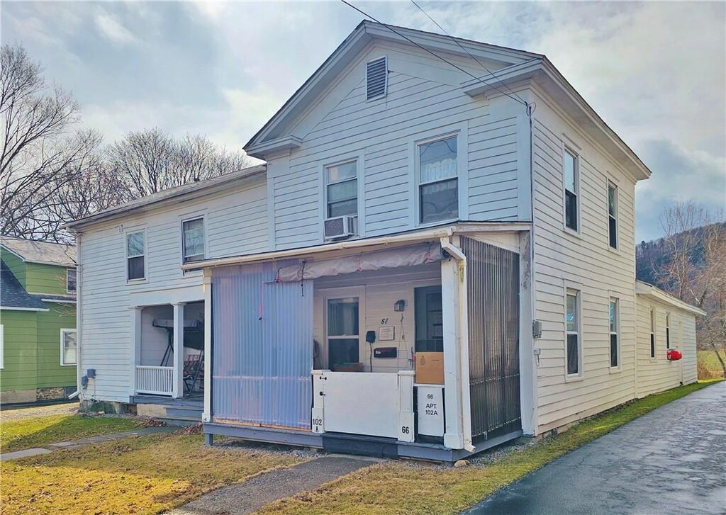 view of front of home with covered porch and cooling unit