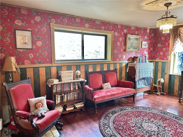 5166 State Highway 41, Smithville, NY 13778 - sitting room with a wainscoted wall, wallpapered walls, wood finished floors, and an inviting chandelier