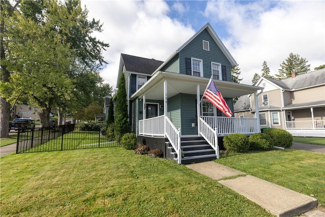 view of front facade featuring a front lawn, covered porch, and fence