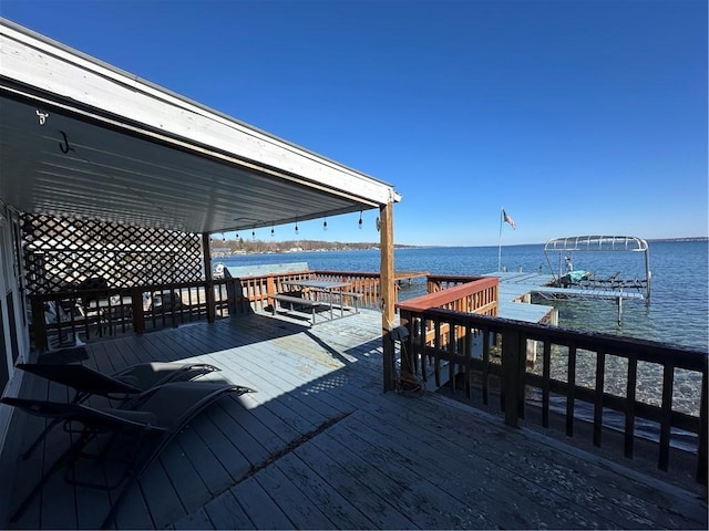 dock area featuring a deck with water view