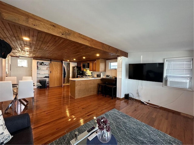 living room with dark wood-style flooring, baseboards, and cooling unit