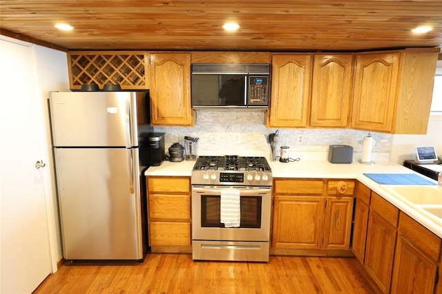 kitchen featuring light wood-type flooring, light countertops, wooden ceiling, and appliances with stainless steel finishes