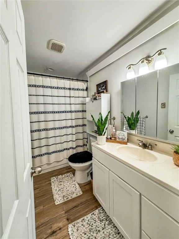 268 Mallory Rd, Chemung, NY 14825 - full bathroom featuring toilet, vanity, wood finished floors, and shower / bath combination with curtain