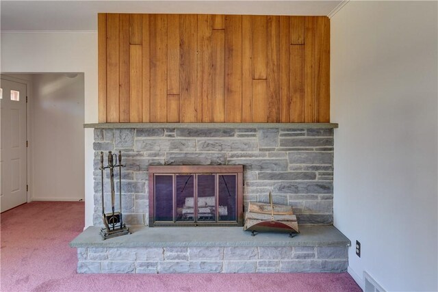 details with crown molding, carpet flooring, baseboards, visible vents, and a fireplace