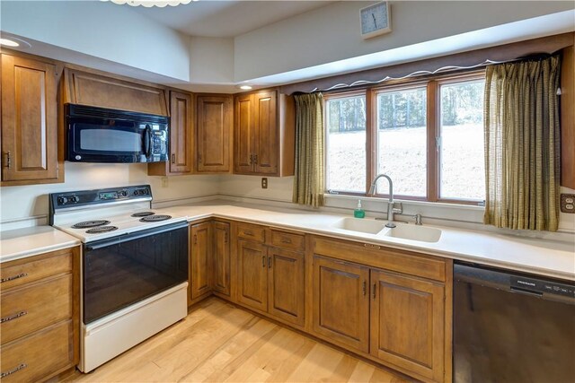kitchen with white electric range oven, dishwasher, brown cabinets, black microwave, and a sink