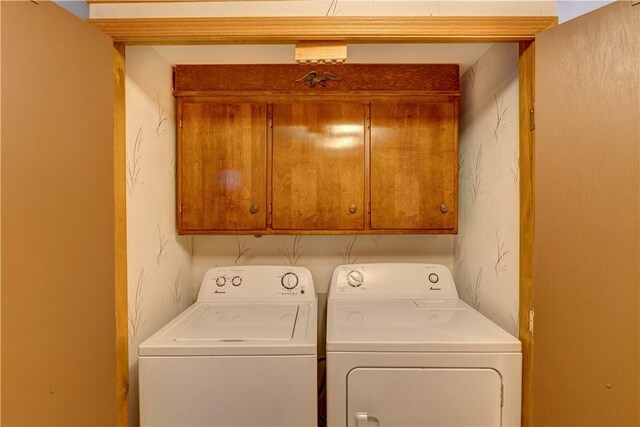 laundry area with cabinet space and washing machine and dryer