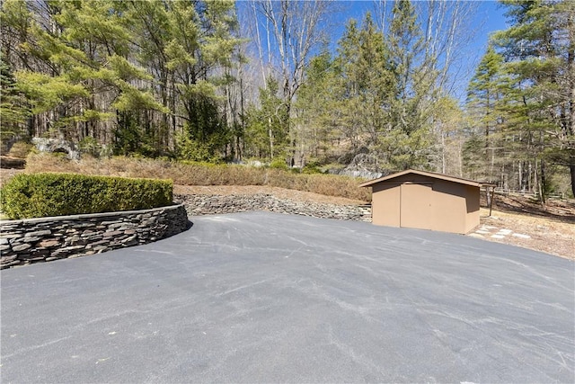 view of patio / terrace featuring an outbuilding and a shed