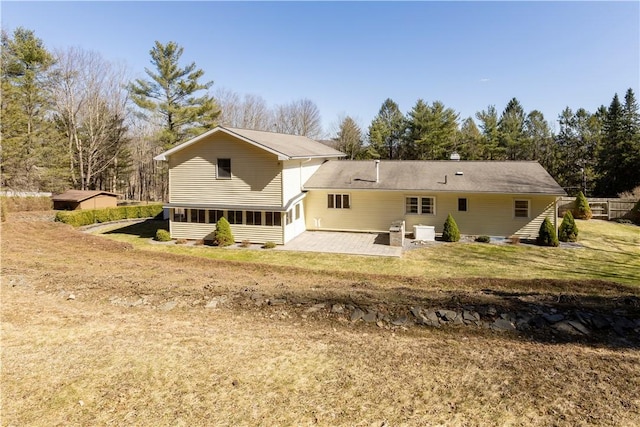 back of property with a patio area and a yard