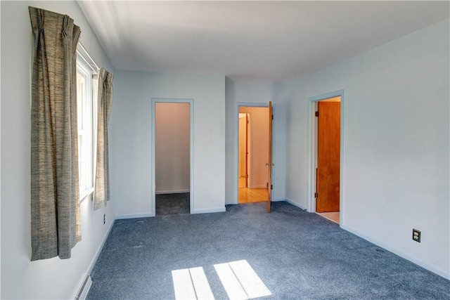 unfurnished bedroom with carpet and baseboards