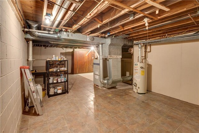 unfinished below grade area featuring heating unit and gas water heater