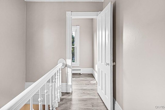 1002 N Madison St, Rome-Inside, NY 13440 - hall with baseboards, an upstairs landing, wood finished floors, and a baseboard heating unit