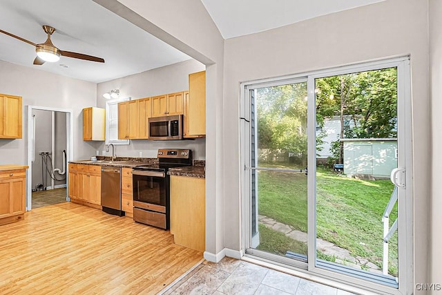 1002 N Madison St, Rome-Inside, NY 13440 - kitchen featuring a sink, dark countertops, light brown cabinetry, and appliances with stainless steel finishes