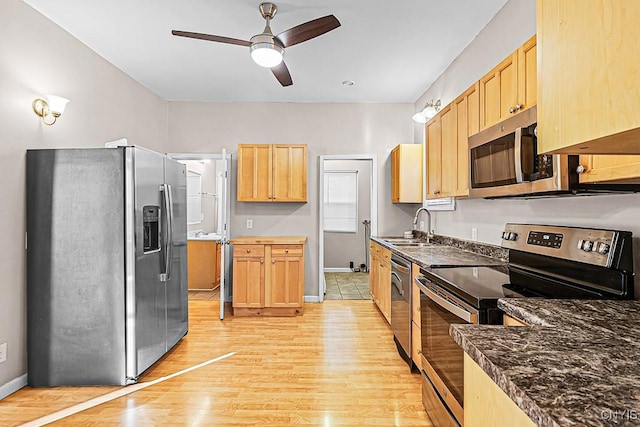 1002 N Madison St, Rome-Inside, NY 13440 - kitchen with stainless steel appliances, light brown cabinetry, a sink, light wood-style floors, and ceiling fan