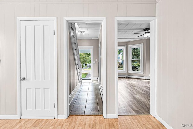 1002 N Madison St, Rome-Inside, NY 13440 - hallway featuring baseboard heating, baseboards, and light wood-type flooring