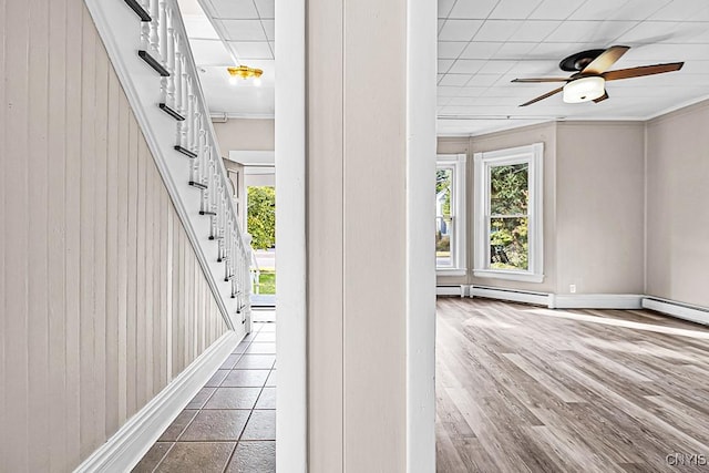 1002 N Madison St, Rome-Inside, NY 13440 - interior space featuring stairs, crown molding, wood finished floors, baseboard heating, and baseboards