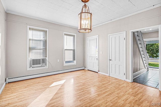 1002 N Madison St, Rome-Inside, NY 13440 - spare room with baseboards, baseboard heating, wood finished floors, and ornamental molding