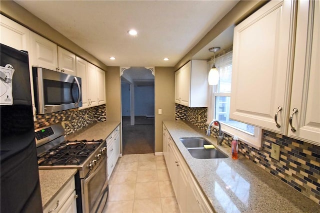 21 Algonquin Dr, Big Flats, NY 14845 - kitchen featuring appliances with stainless steel finishes, backsplash, recessed lighting, white cabinetry, and light stone counters
