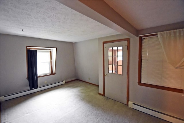 21 Algonquin Dr, Big Flats, NY 14845 - empty room featuring baseboard heating, healthy amount of natural light, carpet flooring, and a textured ceiling