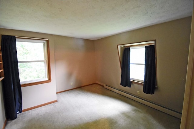 21 Algonquin Dr, Big Flats, NY 14845 - carpeted empty room featuring baseboard heating and baseboards