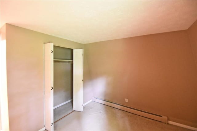 21 Algonquin Dr, Big Flats, NY 14845 - unfurnished bedroom with baseboard heating, a closet, and finished concrete flooring