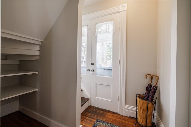 foyer with baseboards and dark wood-style flooring