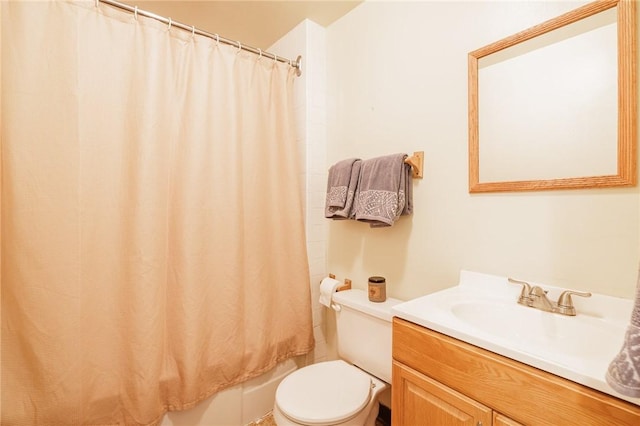 bathroom featuring toilet, vanity, and shower / tub combo