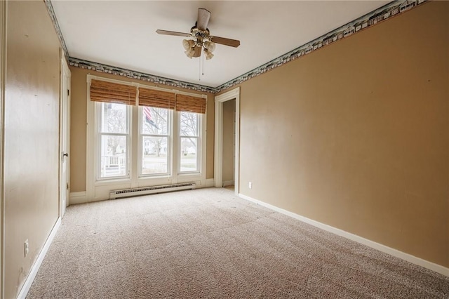 spare room with light carpet, baseboards, a baseboard heating unit, and ceiling fan