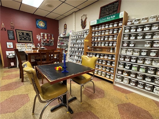 wine area featuring tile patterned floors and a paneled ceiling