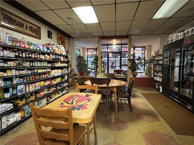 interior space featuring tile patterned floors and a paneled ceiling