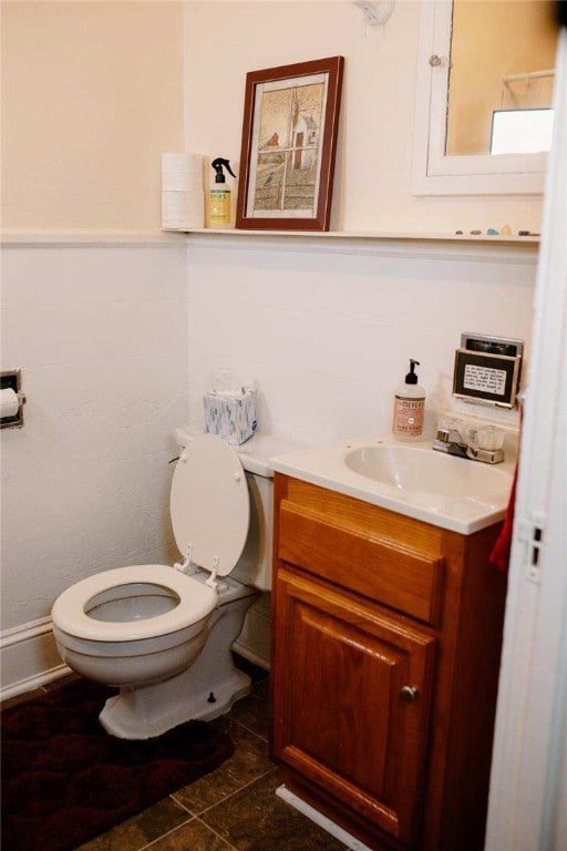 half bathroom featuring toilet and vanity
