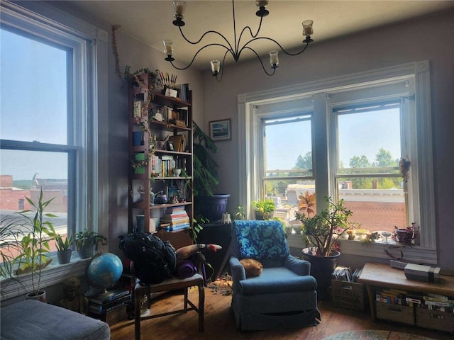 living area with a notable chandelier and wood finished floors