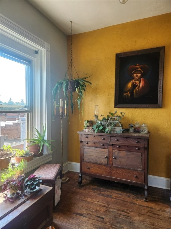 sitting room featuring baseboards and dark wood-style floors