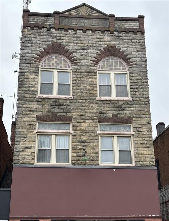 view of side of property with stone siding
