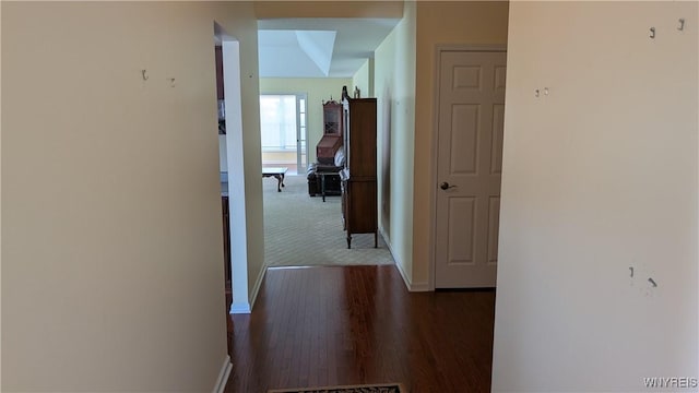 hall with baseboards and dark wood finished floors