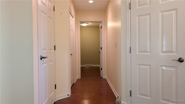 hall with recessed lighting, baseboards, and dark wood finished floors