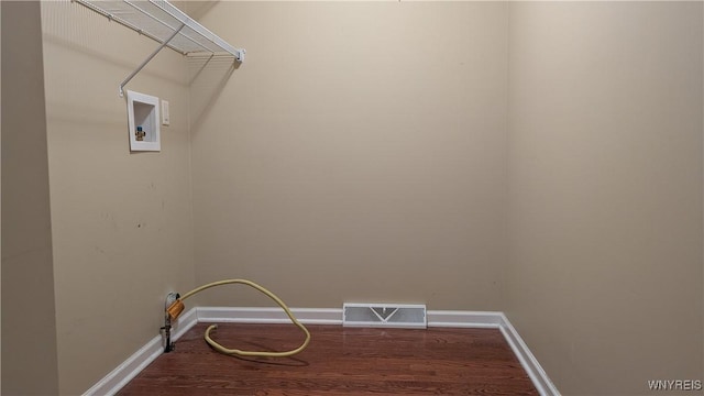 laundry room featuring wood finished floors, baseboards, laundry area, and visible vents