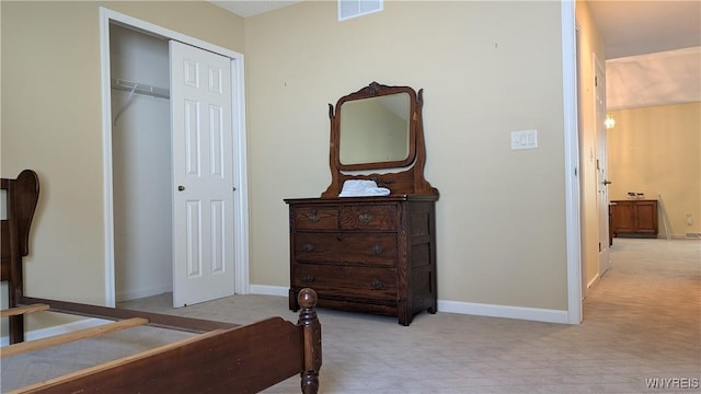 bedroom featuring baseboards, visible vents, a closet, and carpet