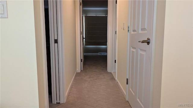 hall featuring baseboards