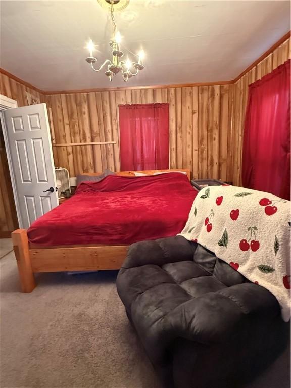 39 Steuben St, Addison, NY 14801 - bedroom featuring wooden walls, carpet floors, ornamental molding, and a chandelier