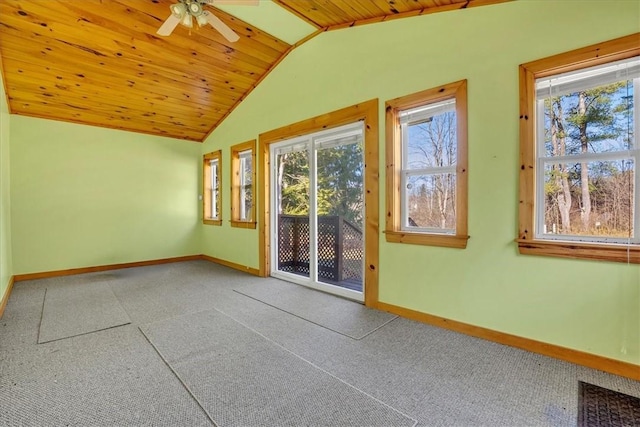 empty room with a ceiling fan, plenty of natural light, baseboards, and vaulted ceiling