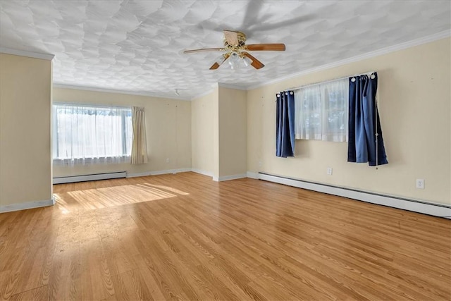 unfurnished room featuring baseboard heating, wood finished floors, ornamental molding, and a ceiling fan