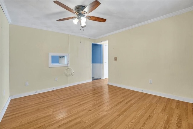 spare room with baseboards, crown molding, light wood-style floors, and ceiling fan