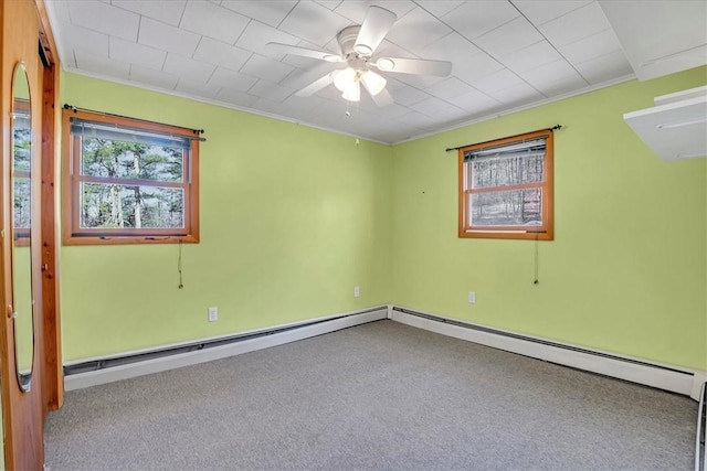 carpeted spare room with crown molding and a ceiling fan