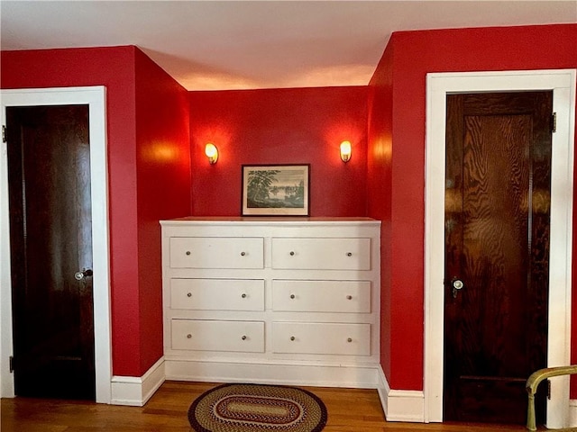 interior space featuring baseboards and wood finished floors