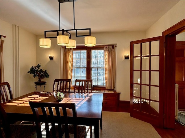dining space with wood finished floors