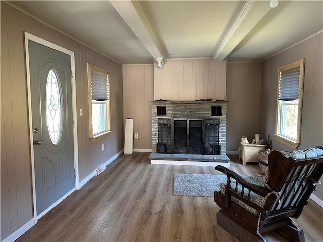 5187 State Highway 23, Norwich-Town, NY 13815 - foyer entrance featuring crown molding, beam ceiling, visible vents, a stone fireplace, and wood finished floors