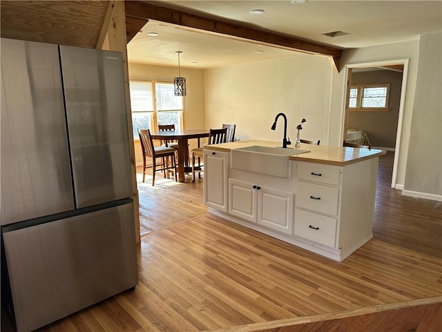 5187 State Highway 23, Norwich-Town, NY 13815 - kitchen featuring a wealth of natural light, a sink, light wood-type flooring, and freestanding refrigerator