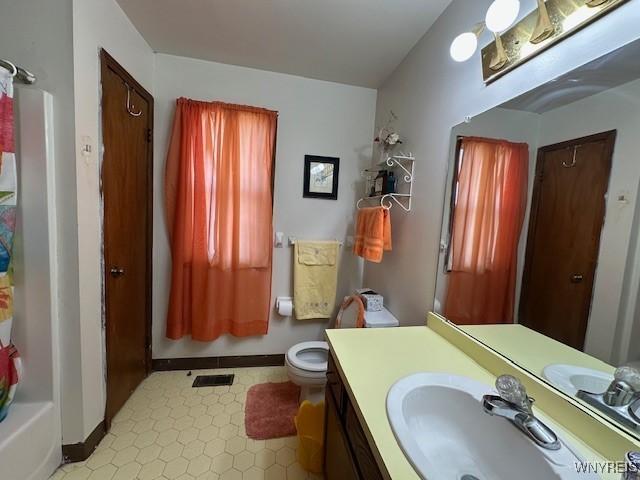 bathroom with baseboards, visible vents, toilet, and vanity