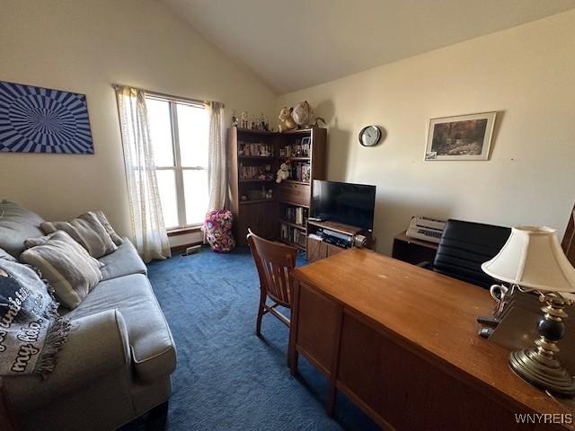 office with lofted ceiling and carpet